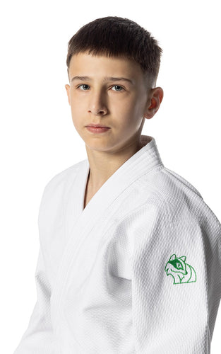 Young person wearing a white judo uniform with a green logo on a white background