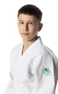 Young person wearing a white judo uniform with a green logo on a white background